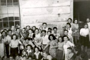 במרחק לא רב מבינדרמיכל, אנס (Enns), מחנה נוסף בפאתי העיר לינץ (Linz). כמו המחנה הגדול בבינדרמיכל, גם אנס הוקם לאחר משבר האמון עם האמריקאים באוקטובר 1945. בתמונה, הצוות המנהל את המחנה עם דיירים צעירים. 
ניתן לזהות את אייזיק גרמן ואשתו חנה, אברהם גירא ואשתו הלה, אסתר פאר ועוד. מפקד התחנה, אברהם ויינגרטן, עומד מאחור, משופם וחיוך על פניו, בין לובש המדים, כומתה לראשו ומשקפי שמש על עיניו, והבחורה בשמלה הכהה ומעליה סינר לבן.